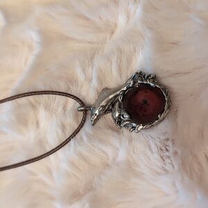 Silver Pendant of Dolphins Leaping over Waves with a Amber Center Focus